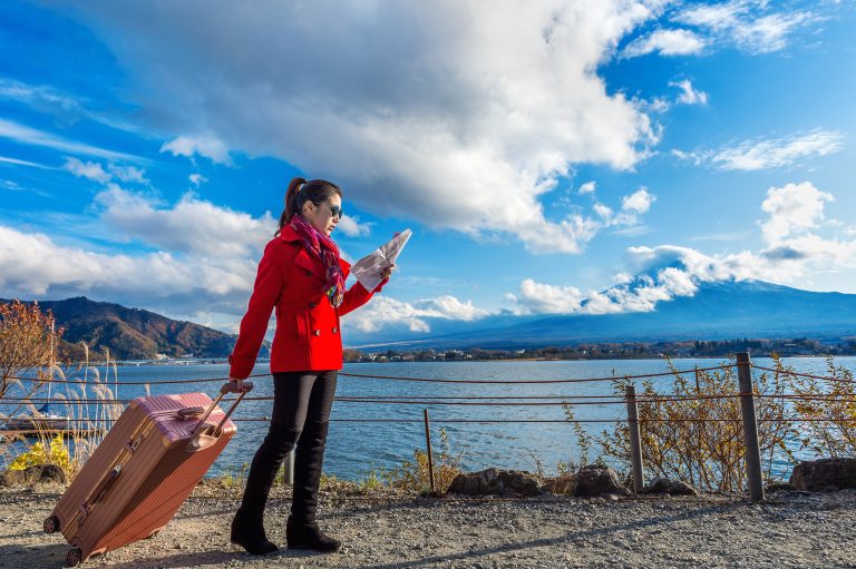 Tourist with baggage and map at Fuji mountain, Kawaguchiko in Ja